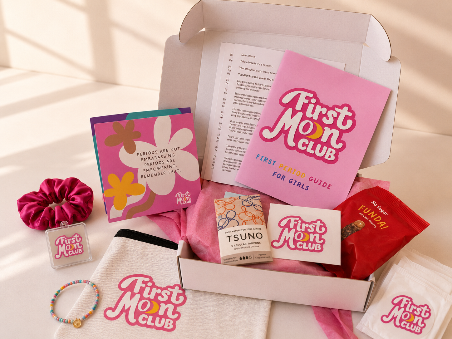 First Moon Club product set with various items including a pink card and accessories on a white background.