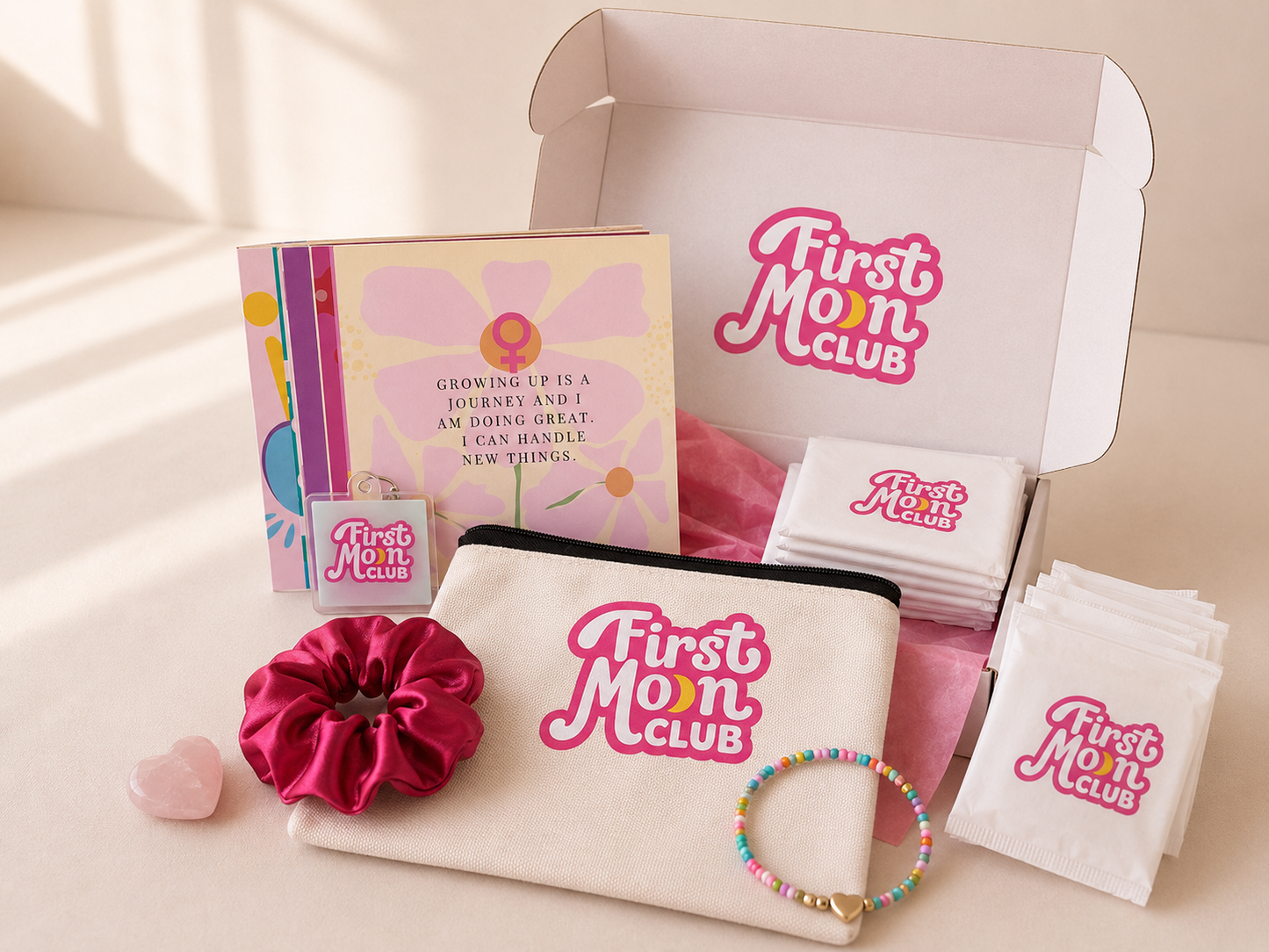 First Mom Club product set including a pouch, scrunchie, and other items on a light background.